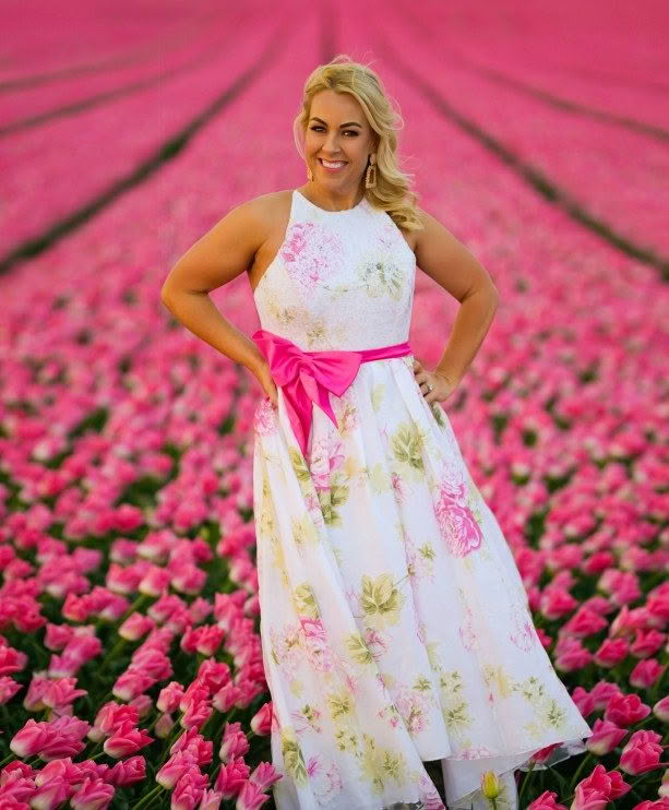 Donna Rae in field of tulips with floral dress